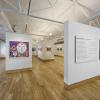 These are custom built "flying" walls that can be rolled across the smooth floor to any position in the gallery giving the museum extraordinary flexibility.